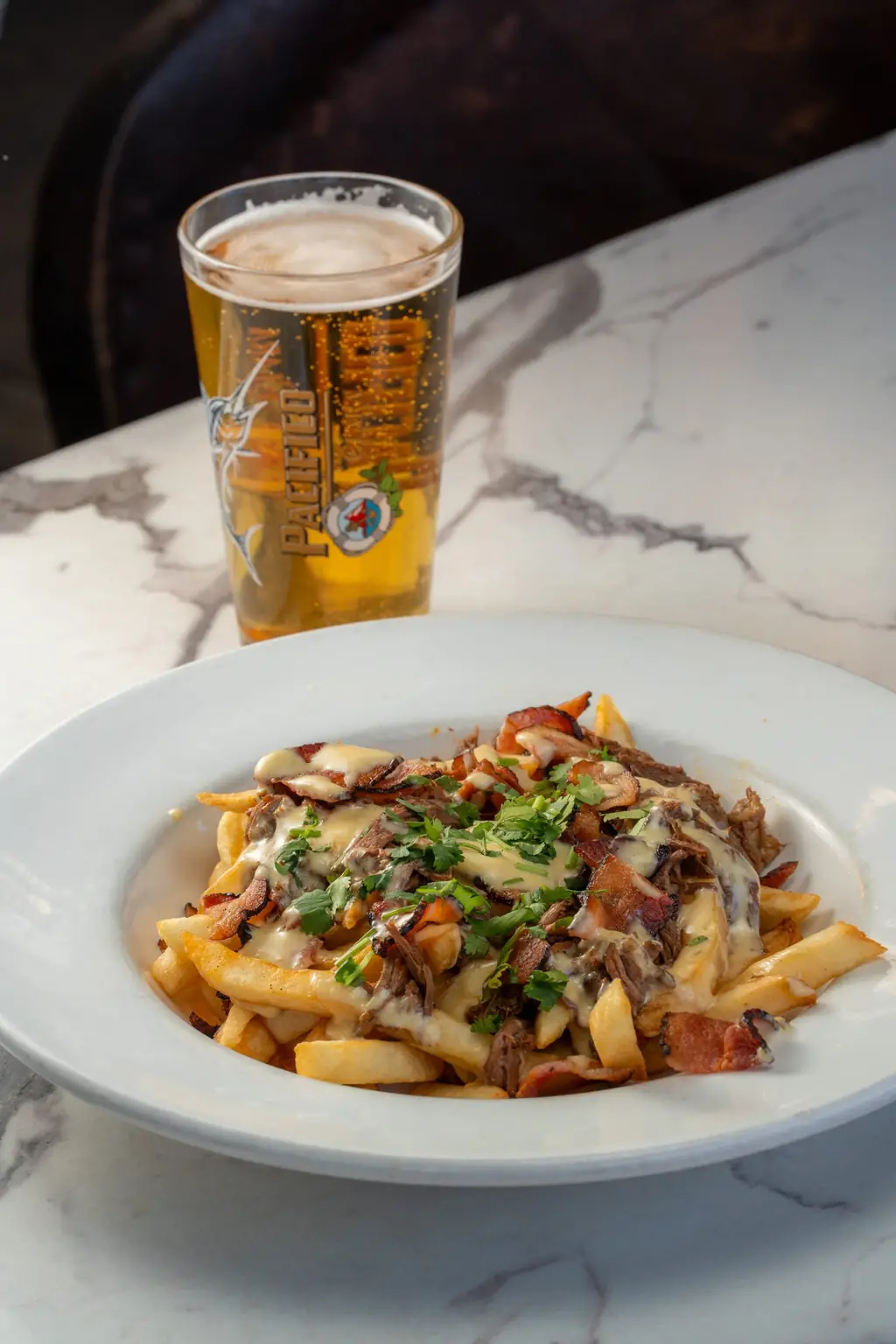 A pint and loaded fries