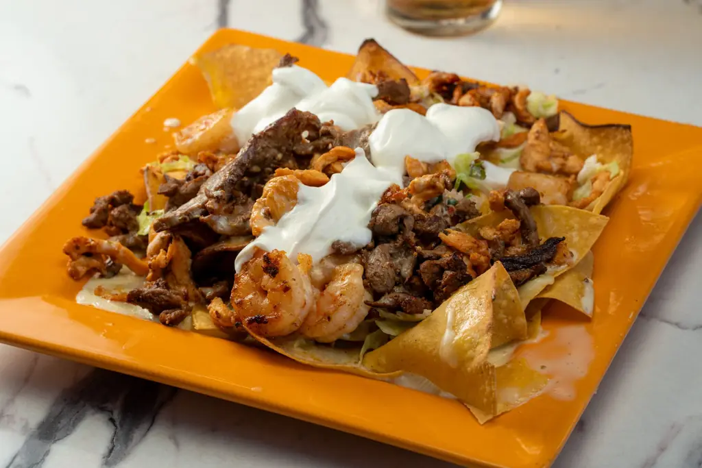Nachos on an orange plate
