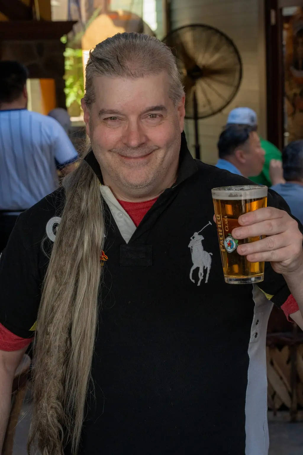 A regular raising a beer