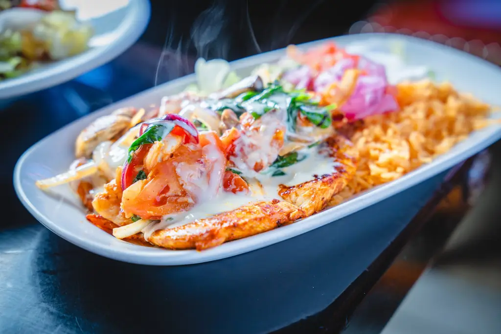 Grilled chicken plate with shrimp and cheese sauce